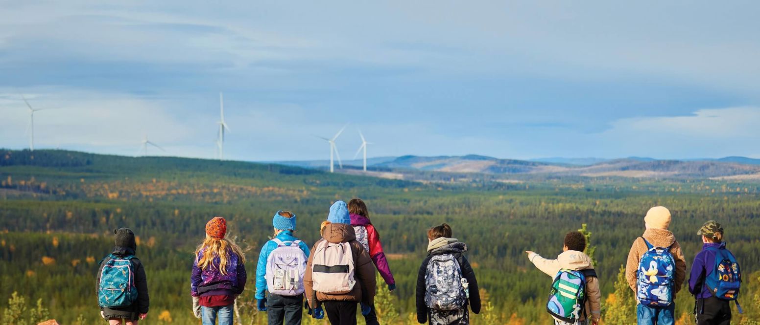 Children looking at a wind farm
